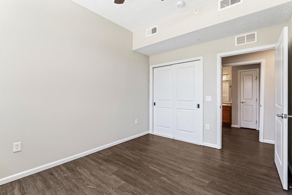an empty living room with white walls and wood flooring