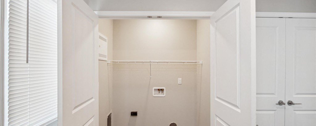 a hallway with white doors and white walls