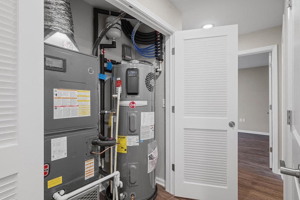A view of a furnace and air conditioner unit installed in a wall.