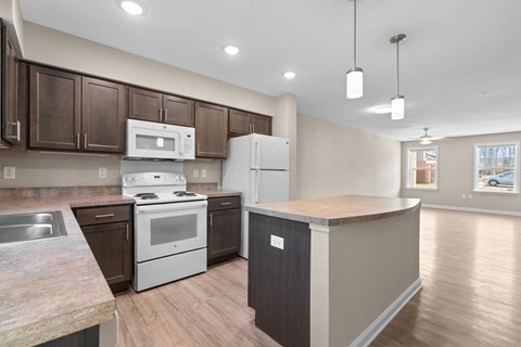 A kitchen with brown cabinets and a white stove top oven.