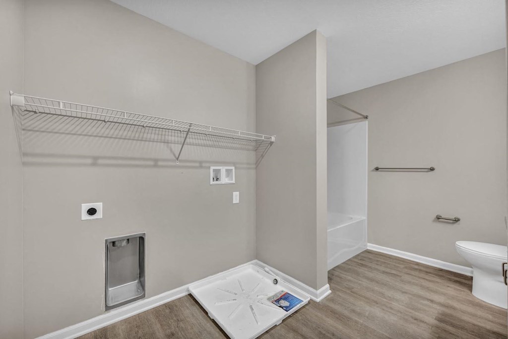 a bathroom with a shower and a toilet in a room