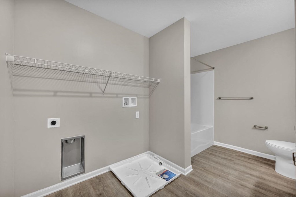 a bathroom with a shower and a toilet in a room