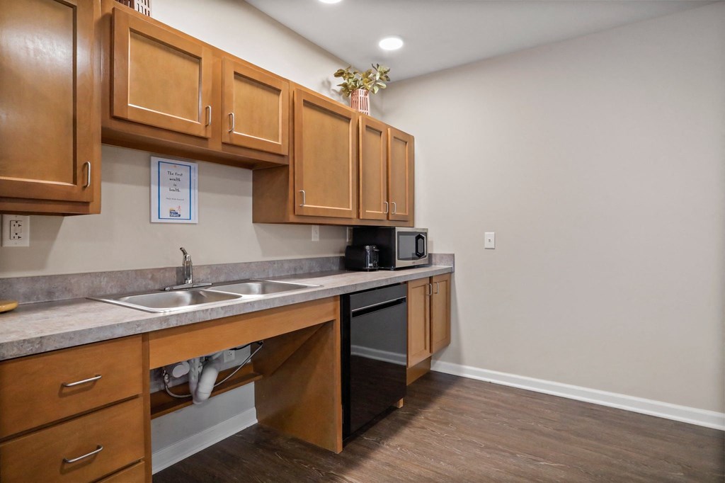 a kitchen with wooden cabinets and a stainless steel dishwasher