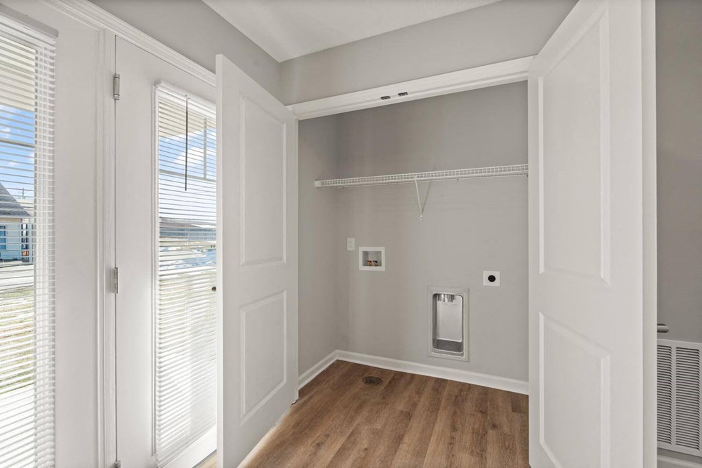 A white closet with a door and a window.