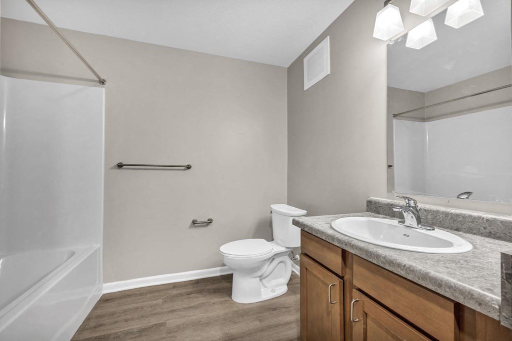 a bathroom with a sink and a toilet and a shower