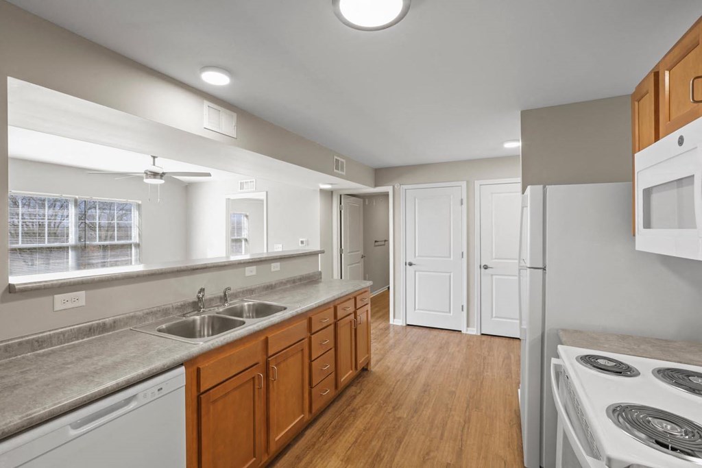 a kitchen with a stove and a sink and a refrigerator
