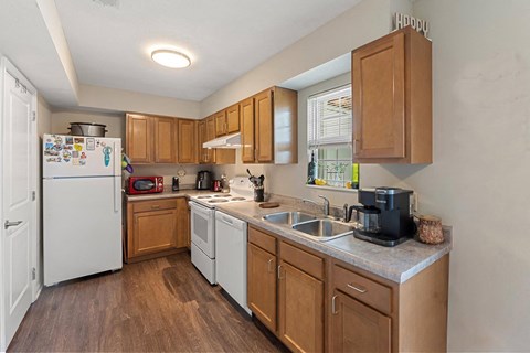 a kitchen with white appliances and wooden cabinets