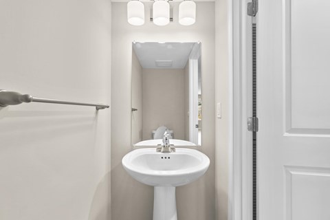 A white sink in a small bathroom.