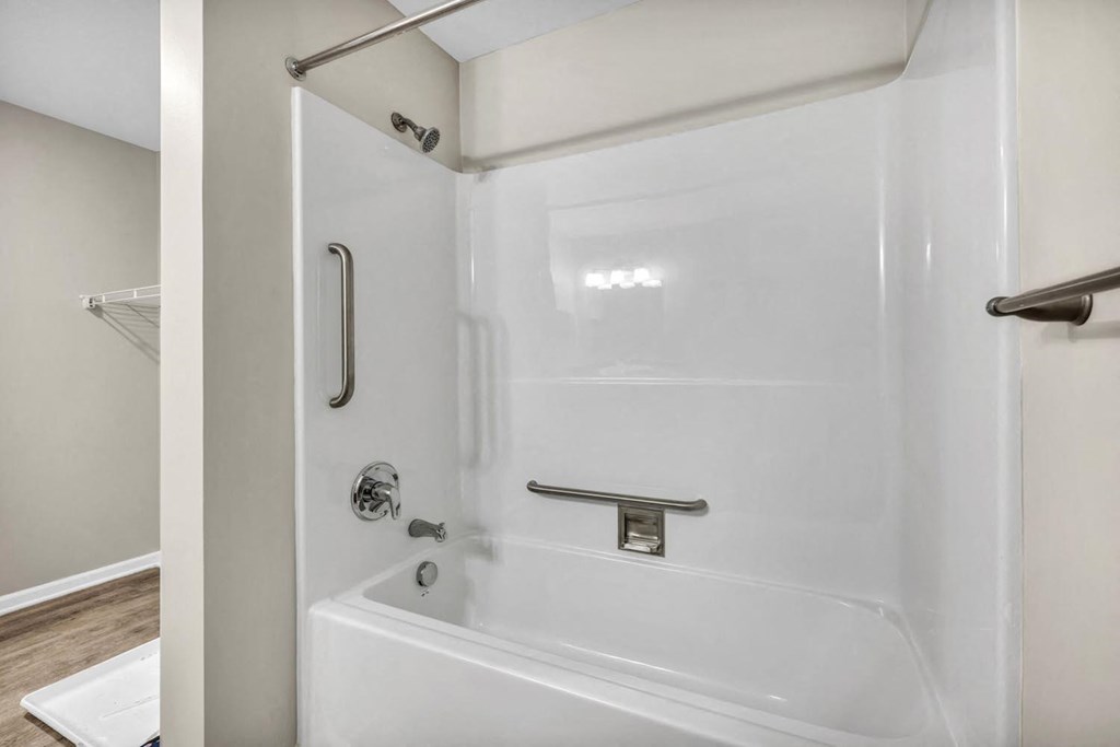 the shower in the master bathroom has a geometric design on the ceiling