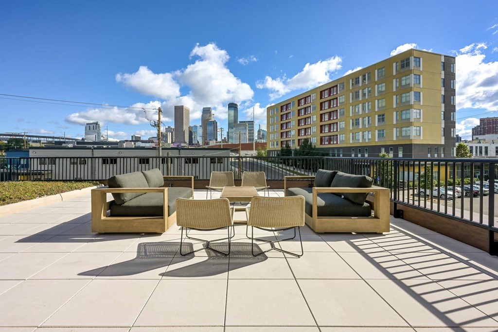 a roof deck with furniture and a view of the city