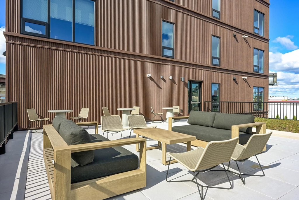 a patio with tables and chairs outside of a building