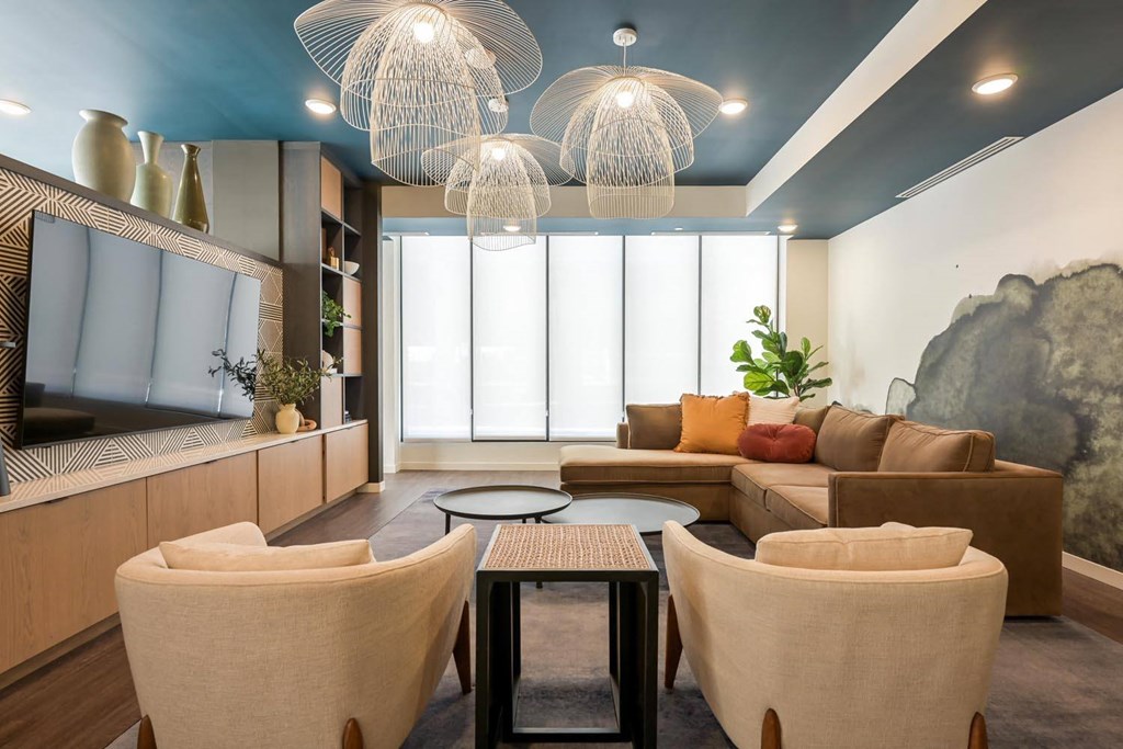 a living room with couches and chairs and a television