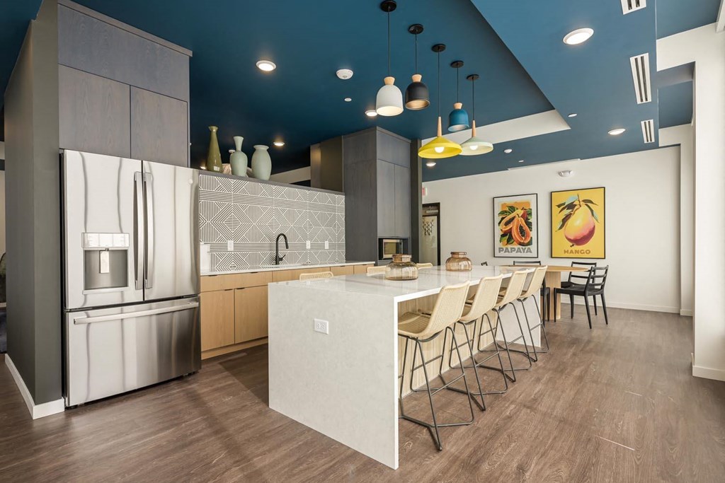 a kitchen with a long counter and a refrigerator