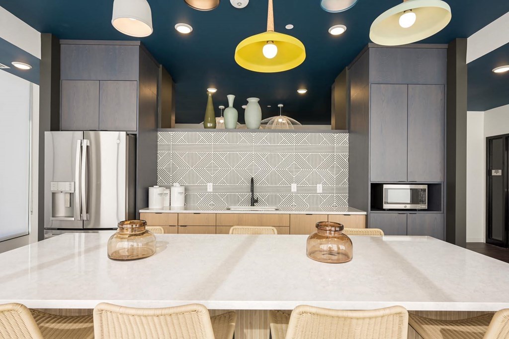 a kitchen with blue ceilings and a white counter top