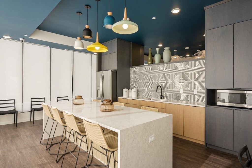 a kitchen with a large white counter top