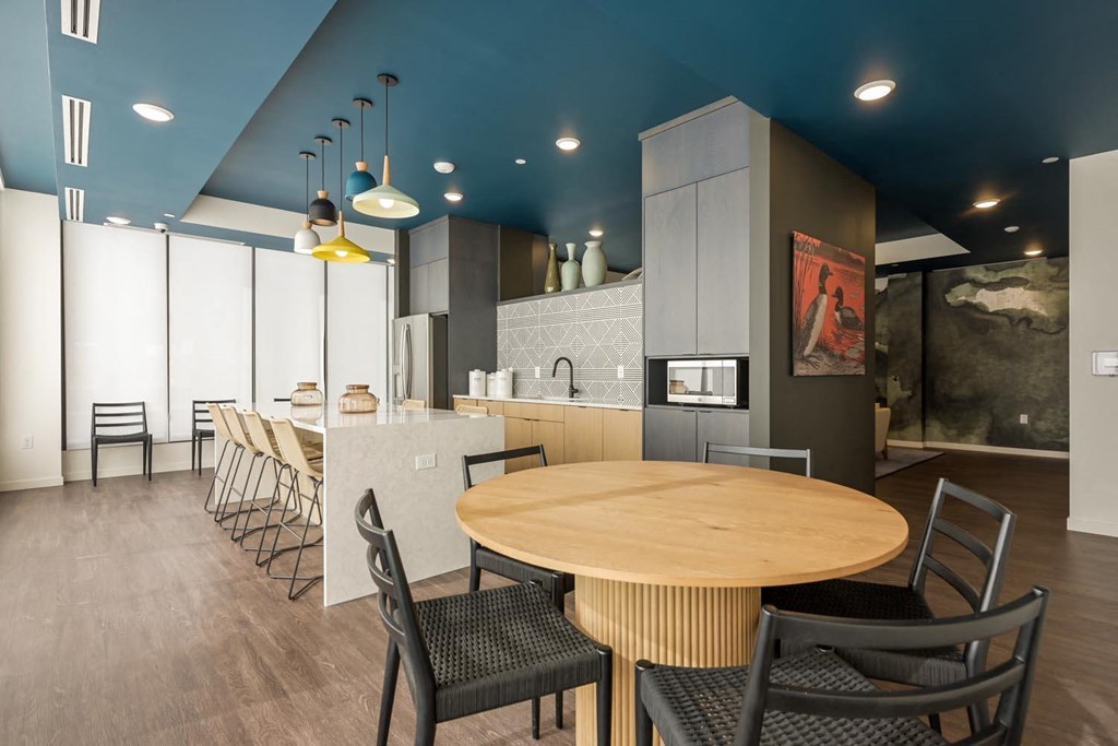 a kitchen and dining room with a table and chairs