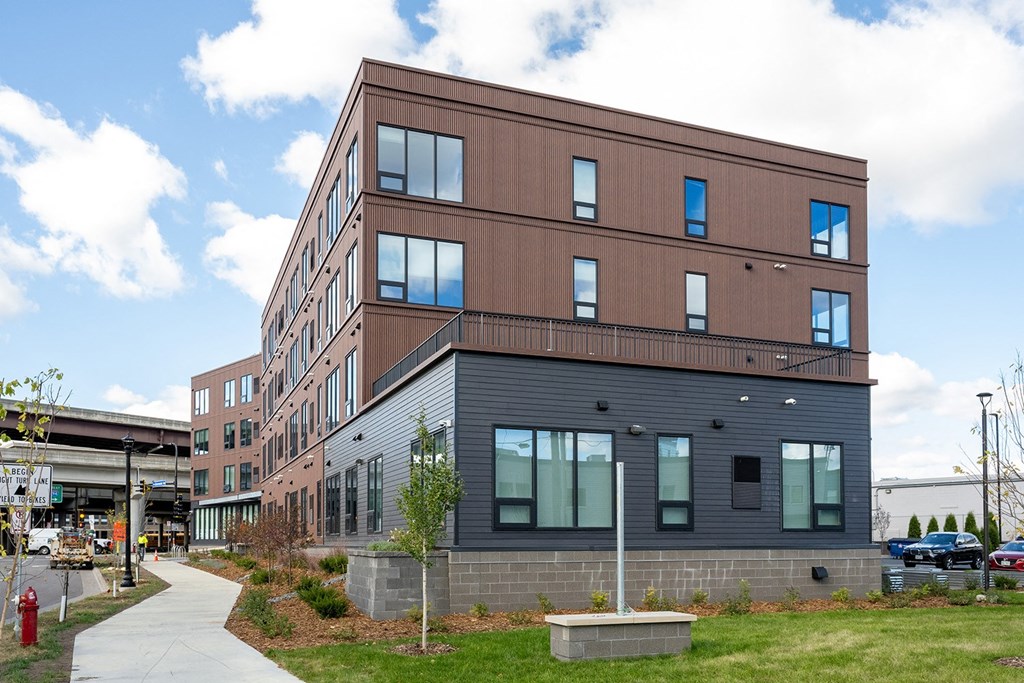 a large building with a sidewalk in front of it