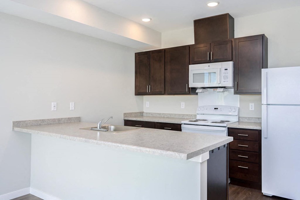 a kitchen with a counter top and a refrigerator
