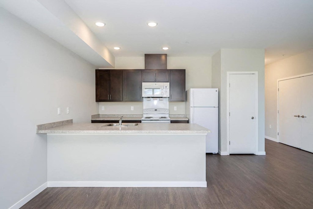 a kitchen with a counter top and a refrigerator