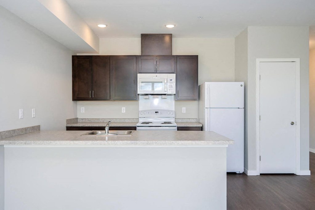 a kitchen with a counter top and a refrigerator