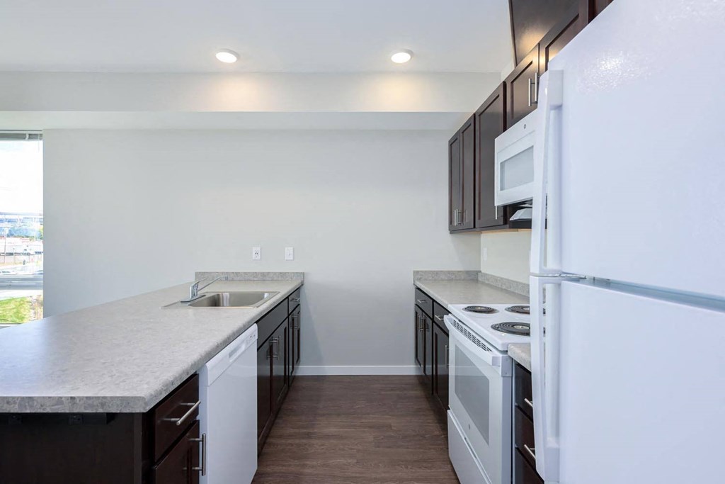 a kitchen with white appliances and black cabinets