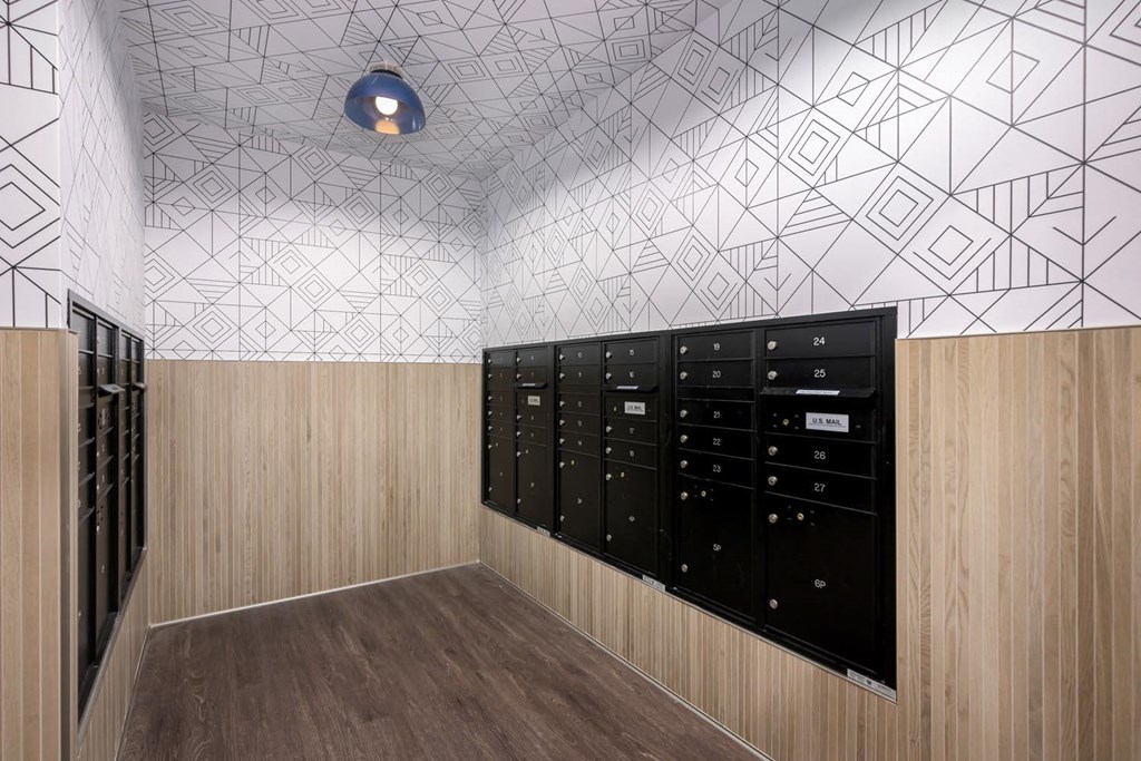 a locker room with a bunch of lockers and a wall with geometric wallpaper