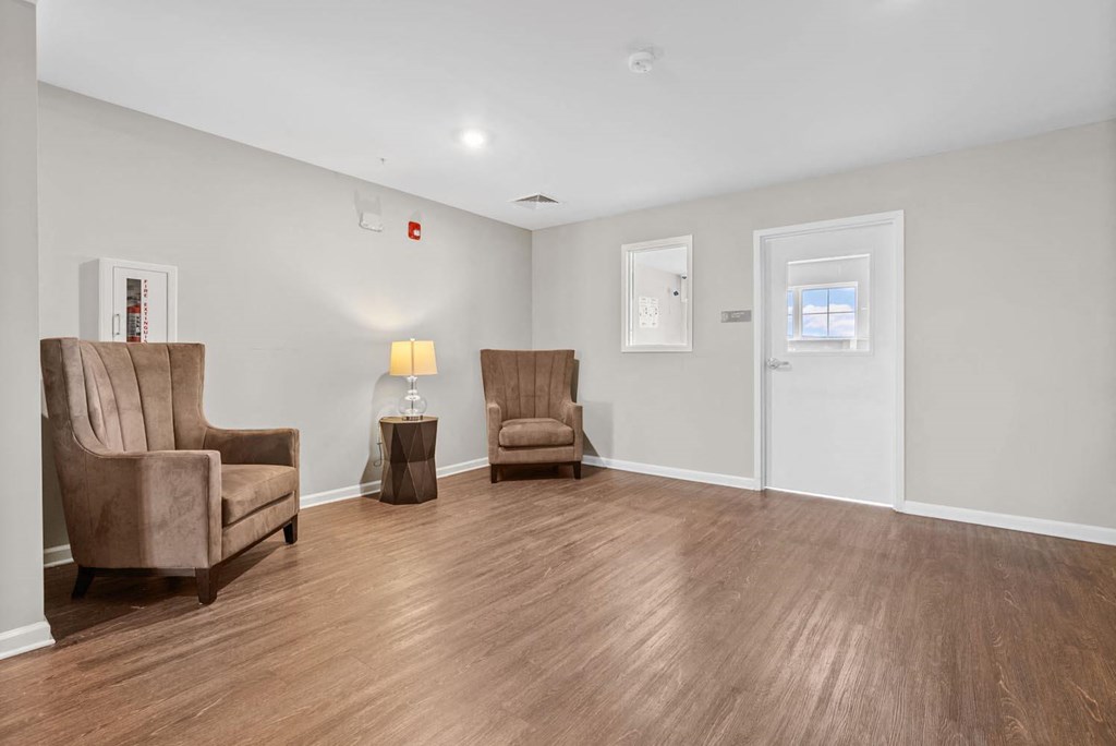 a living room with white walls and a wooden floor