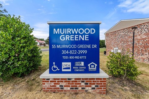 the sign for the greene gas company is in front of a building