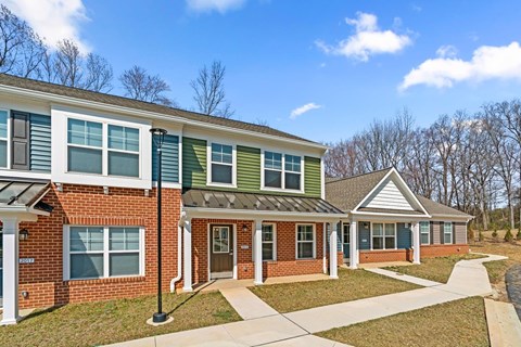 A row of houses with green and red siding.