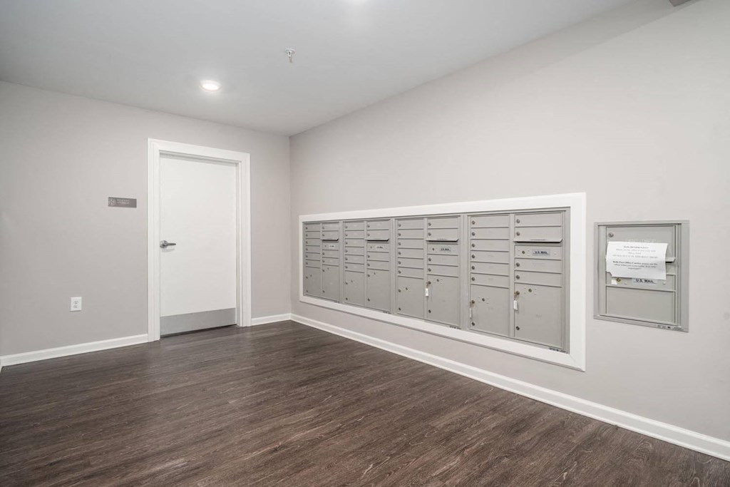 a white room with a bunch of lockers and a door