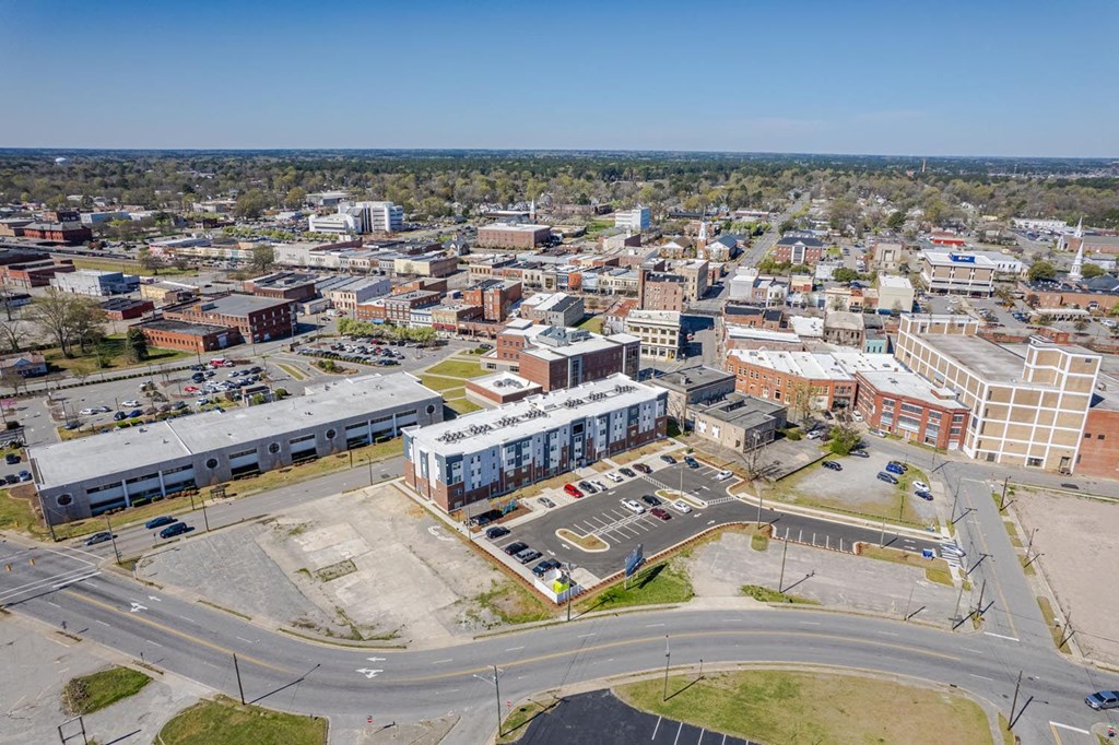 an aerial view of a city with buildings and a parking lot