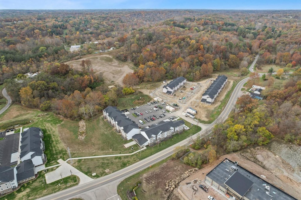 an aerial view of a parking lot and buildings