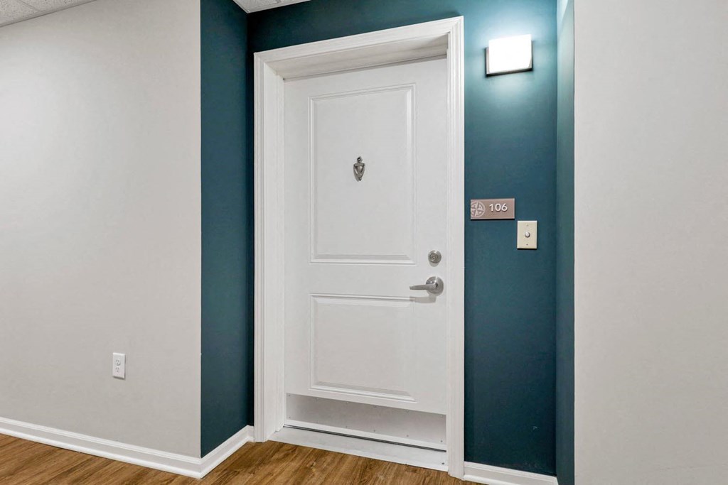 a room with a door and a blue wall and a white door