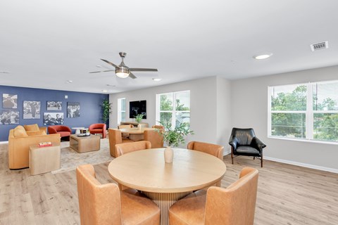 A spacious room with a round table and chairs.