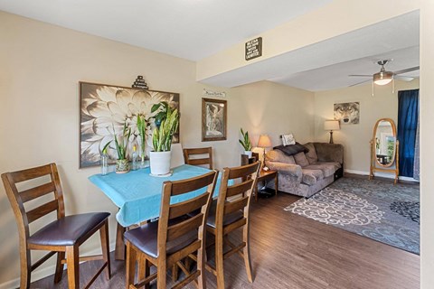 a living room and dining room with a table and chairs