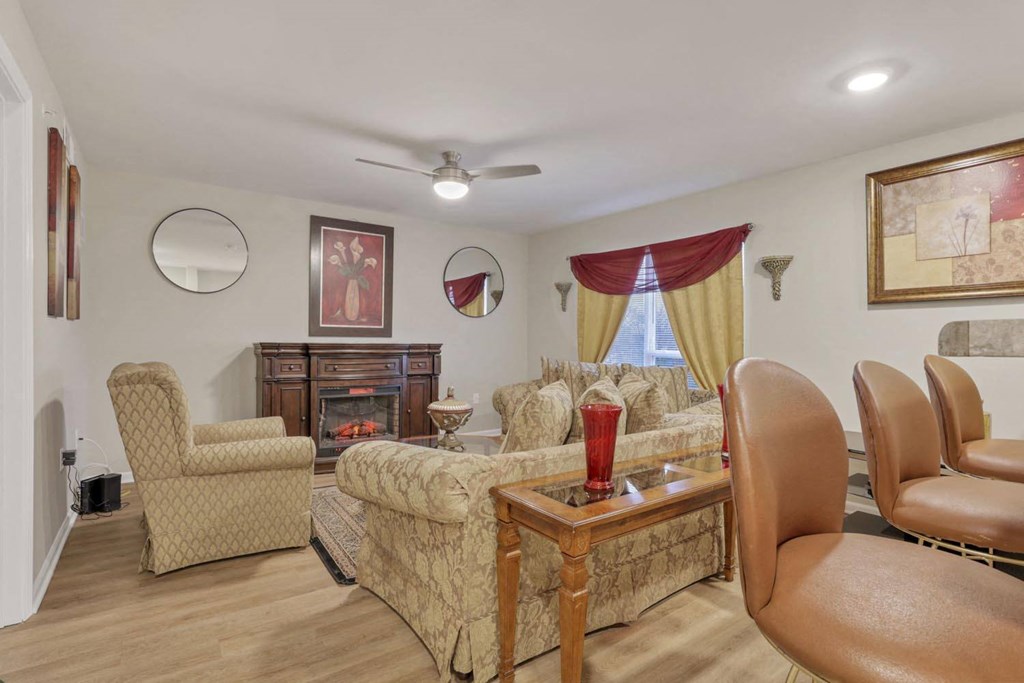 a living room with a couch and chairs and a fireplace