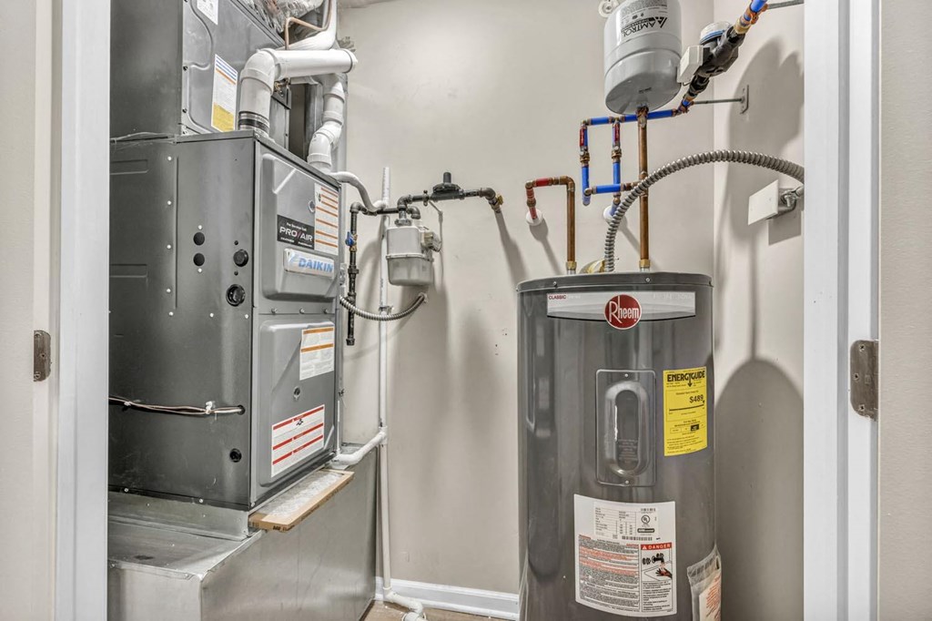 an image of a heating system in a room with a boiler and a gas furnace