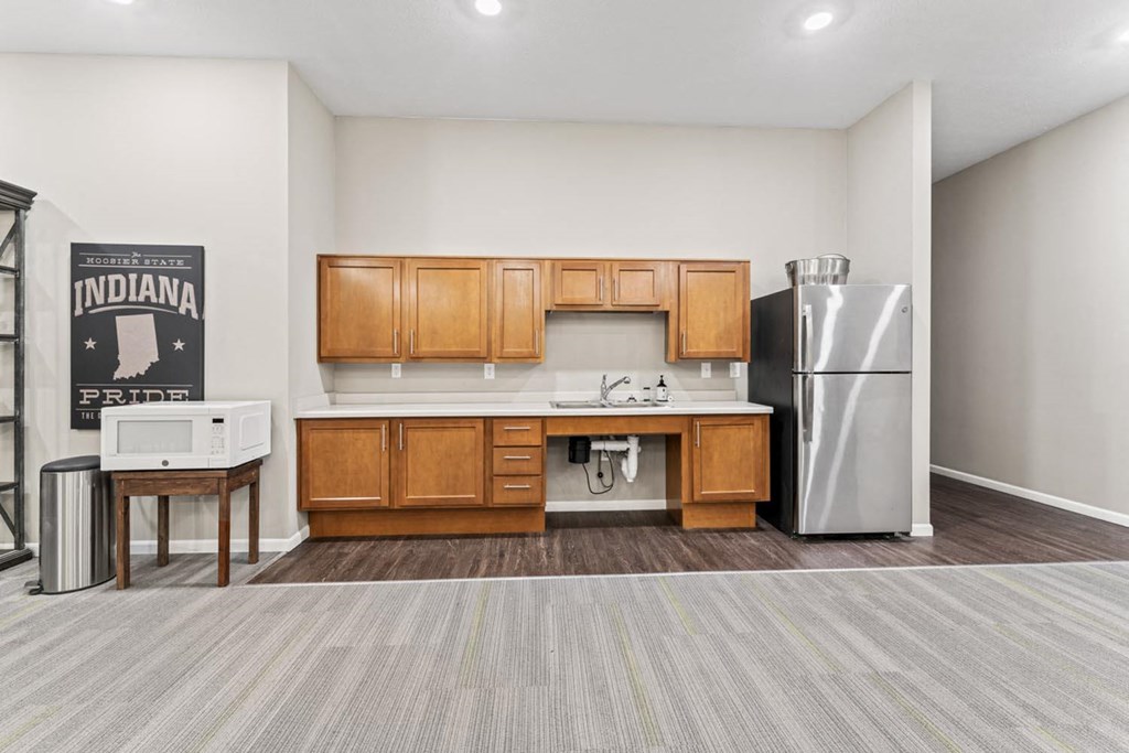 a kitchen with wooden cabinets and a stainless steel refrigerator