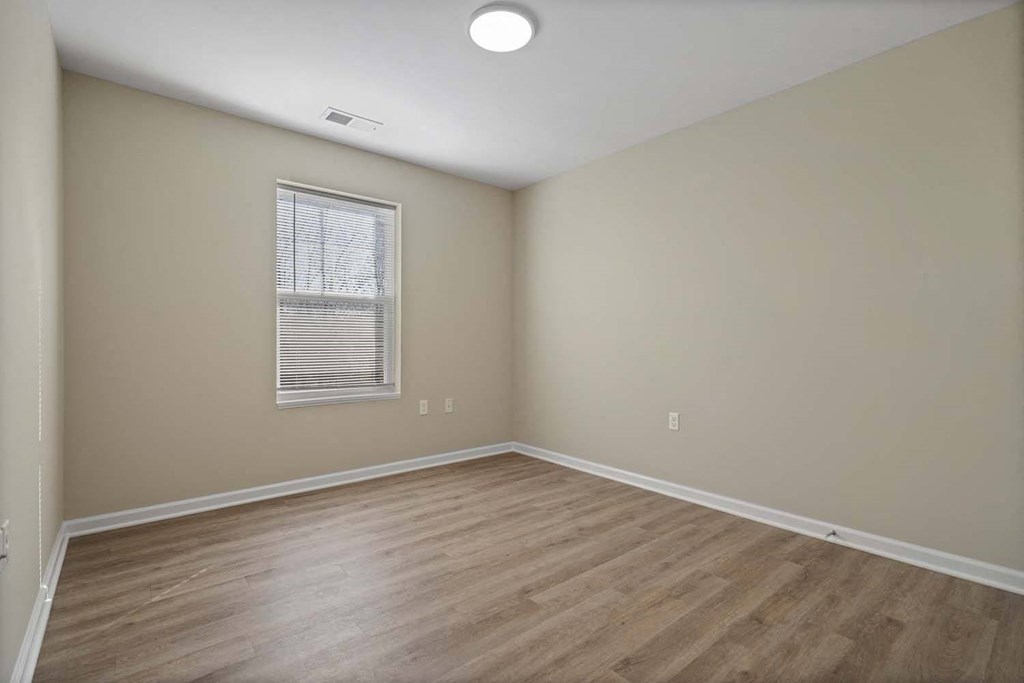 an empty living room with a hard wood floor