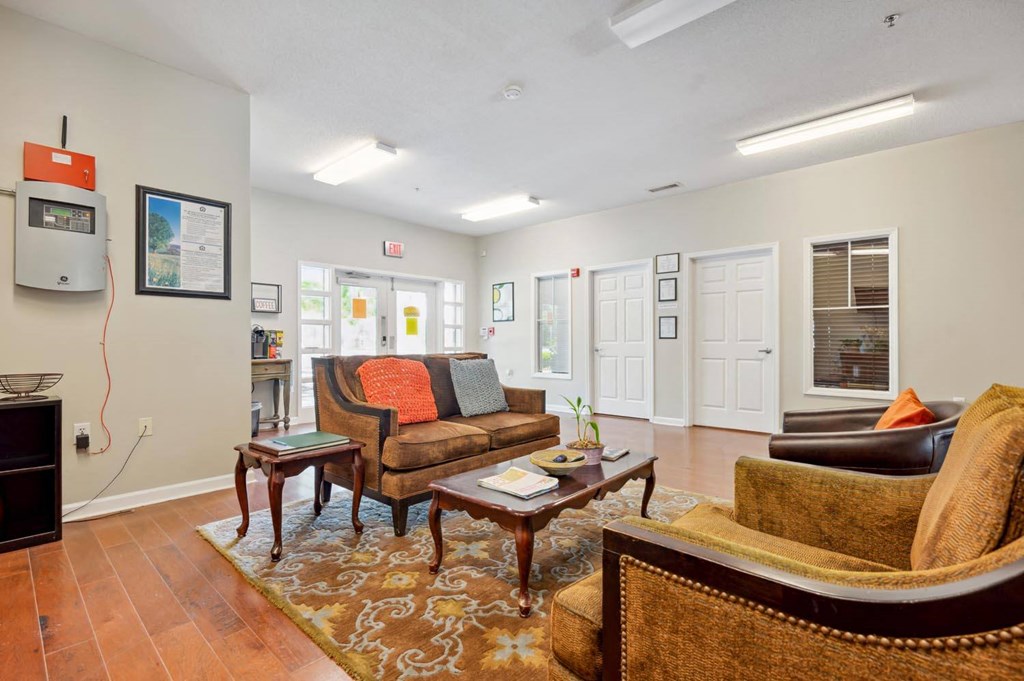 a living room with couches and chairs and a television