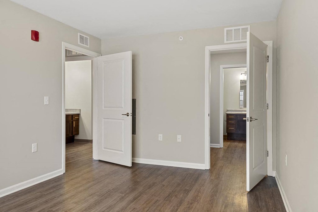 a living room with a hard wood floor and white doors