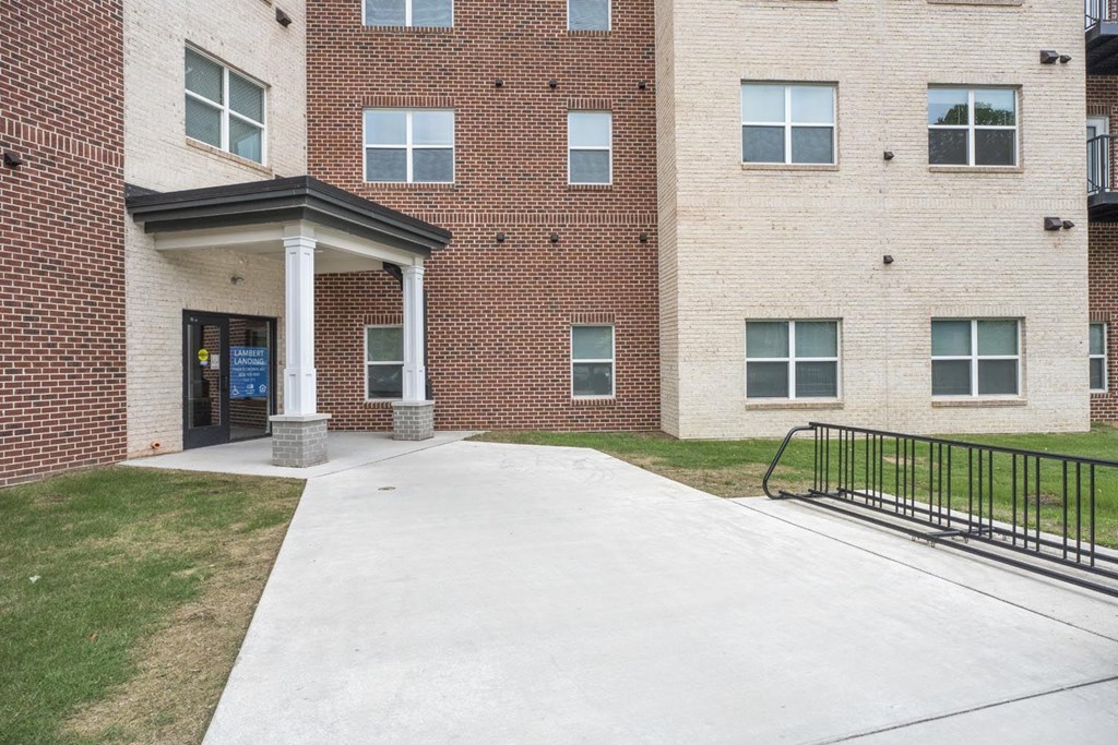 A brick building with a blue sign on the door.