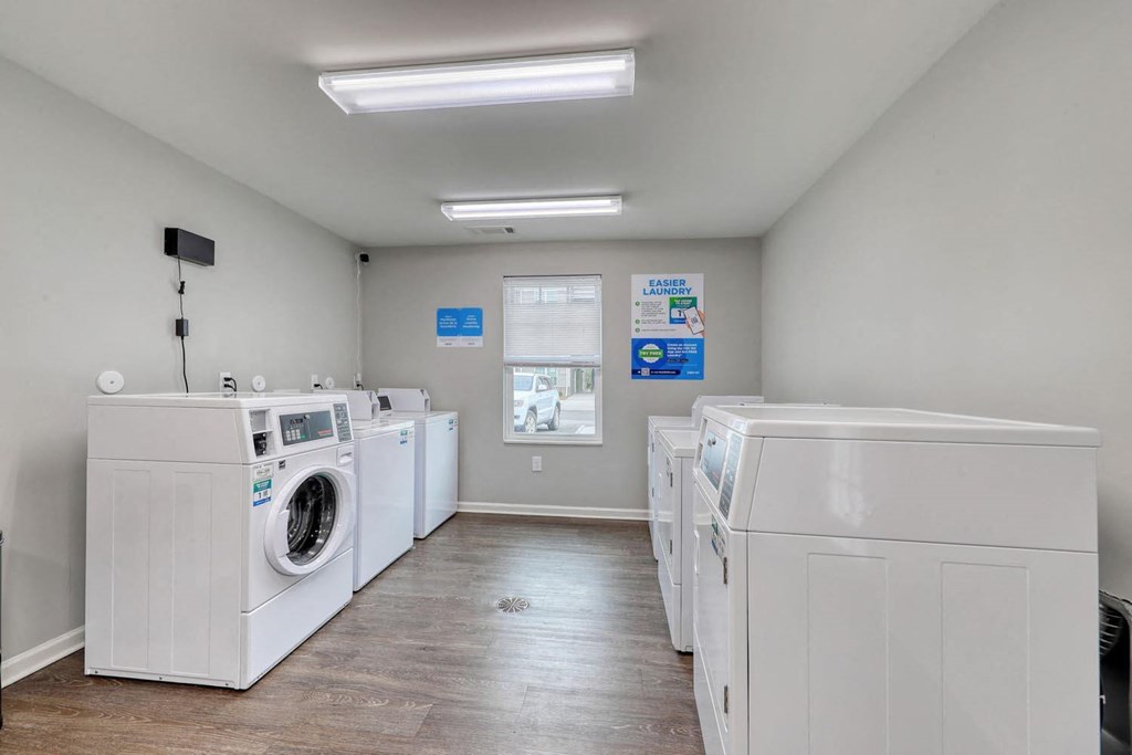 laundry room with washers and dryers at the preserve at great pond apartments in windsor