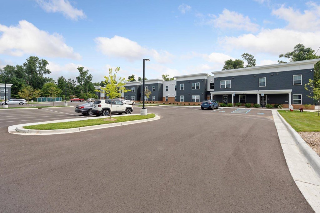 a parking lot with cars in front of a building