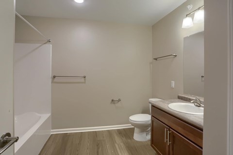 A bathroom with a toilet, sink, and bathtub.