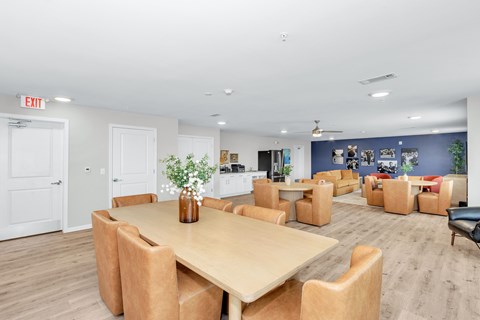 A conference room with a long table and chairs.