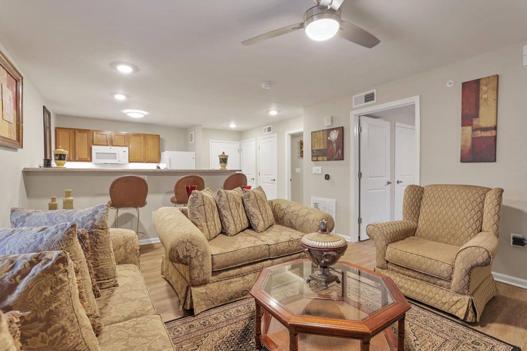 a living room with couches and chairs and a table