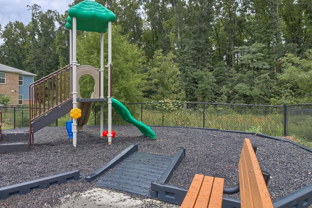 a playground with a slide and other toys in a park