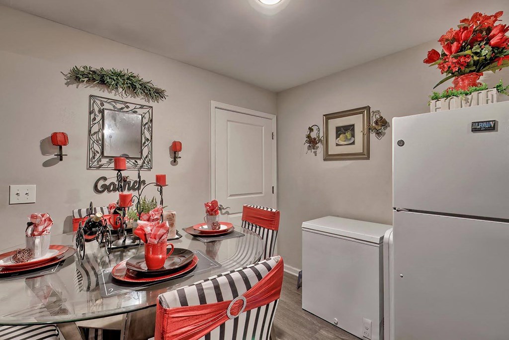 a kitchen and dining room with a table and refrigerator