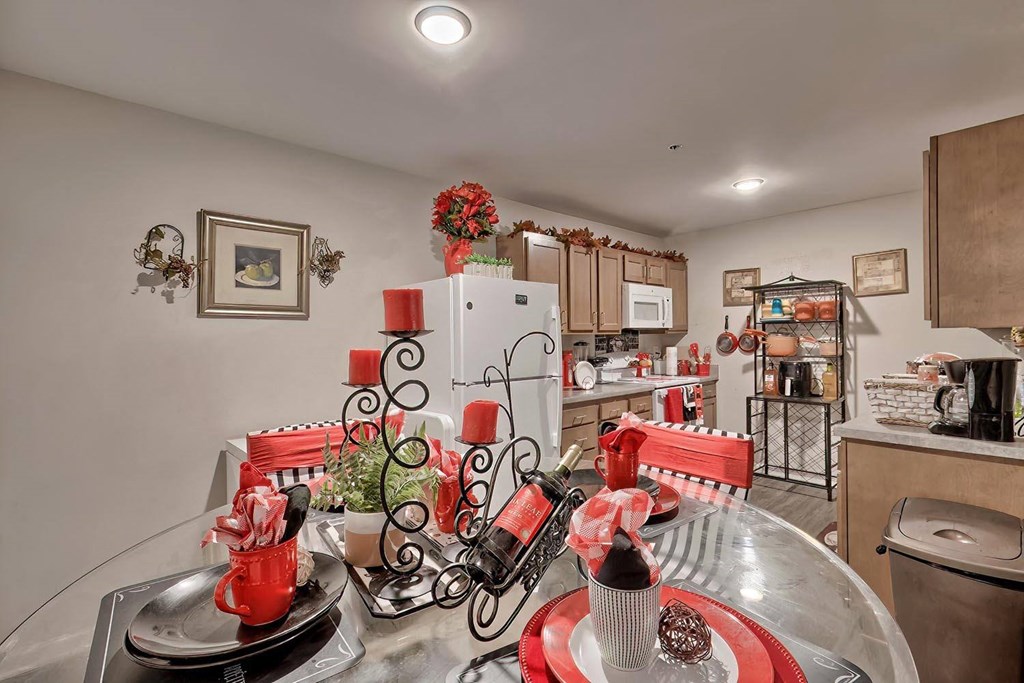 a kitchen with a dining table and a refrigerator